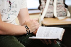 Closeup of male student reading bible