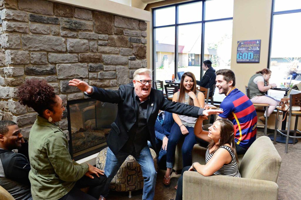 Students with a professor all laughing