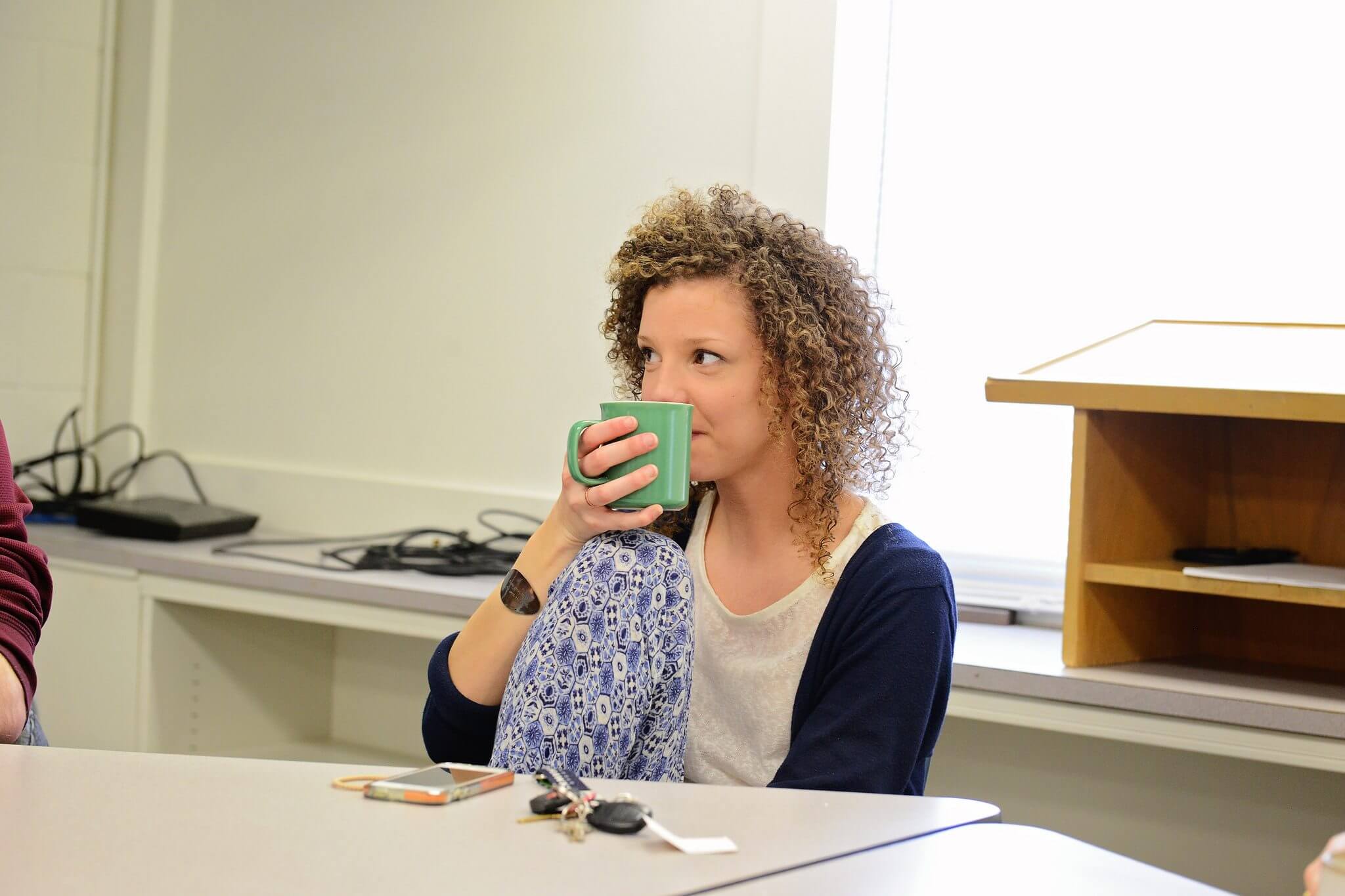 Girl drinking coffee at desk