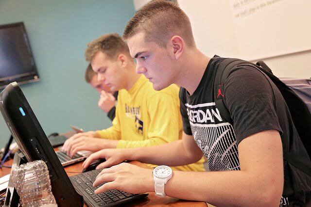 students sitting at a computer