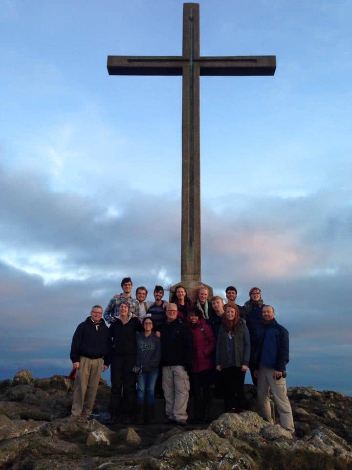 Ireland mission trip team in front of a cross