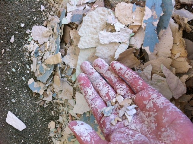 hand covered in chipped paint