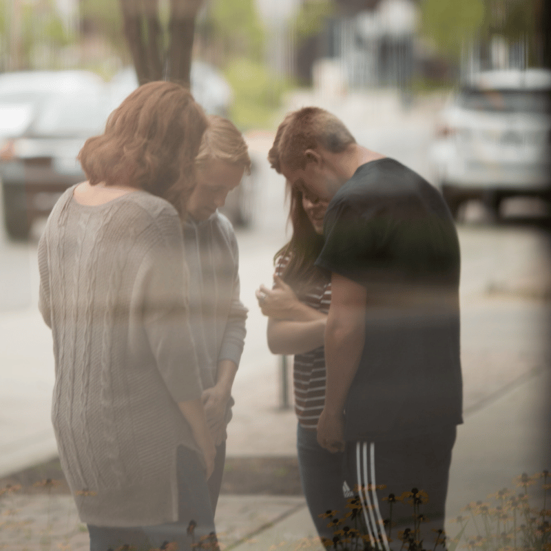 group standing and praying