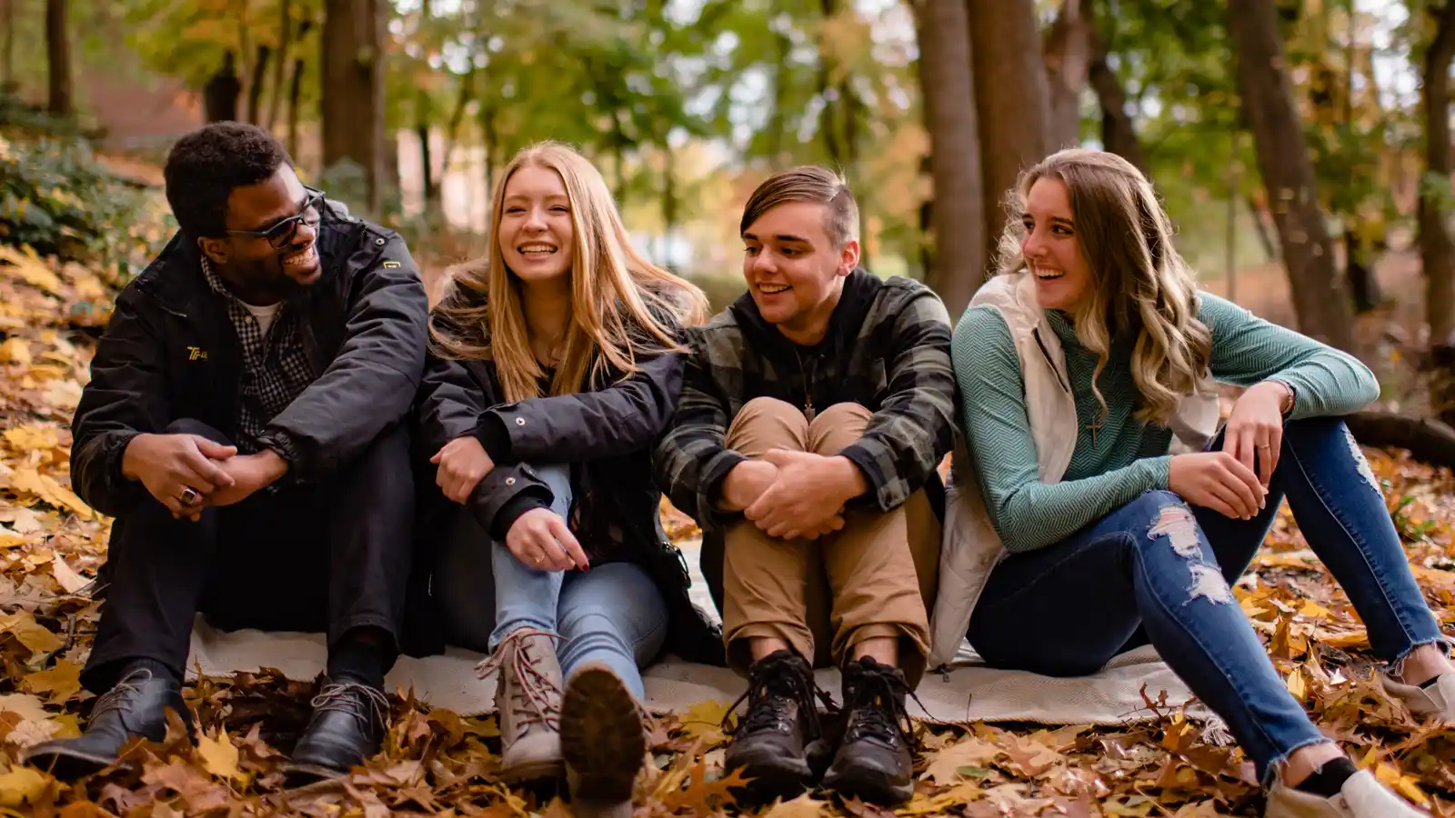 A diverse group of happy students outside