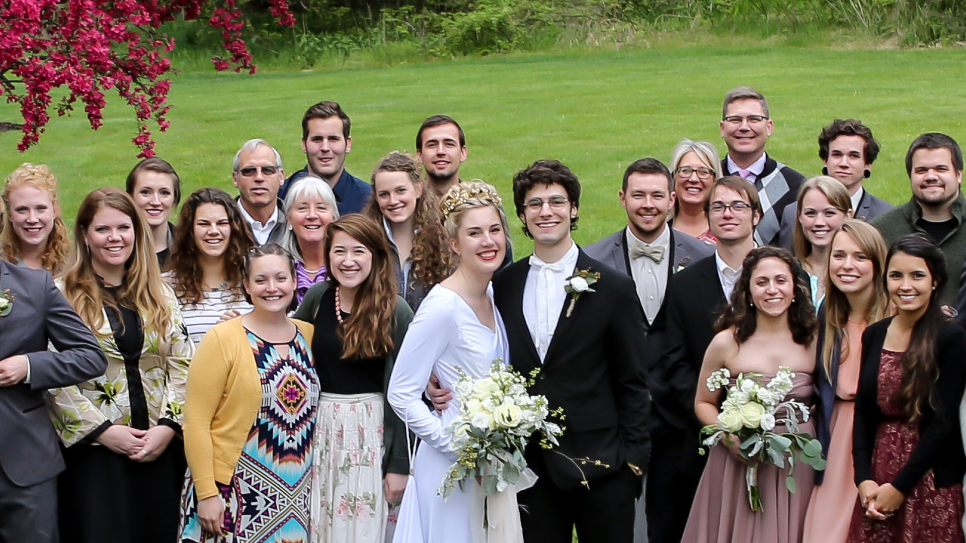 Kyle and Hilary Vegh at their wedding with a group of attendees.