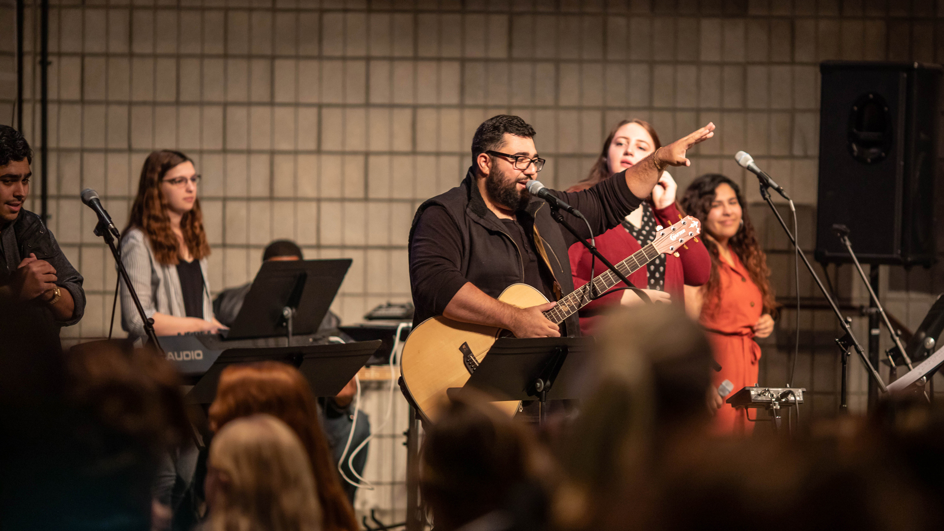 Grace students serving the campus by leading people in worship during a Chapel service.