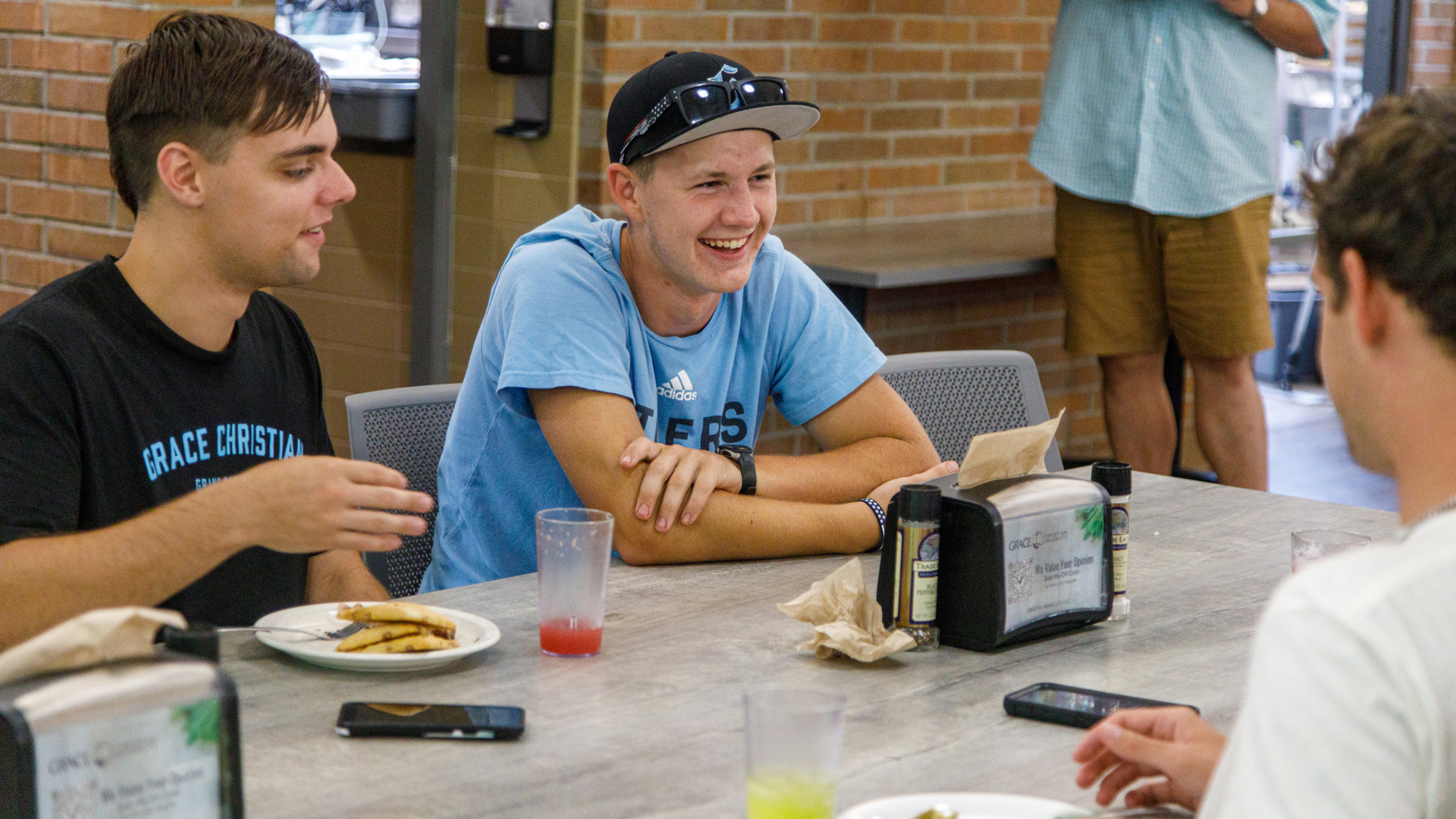 Grace students sitting at tables in the Dining Hall.