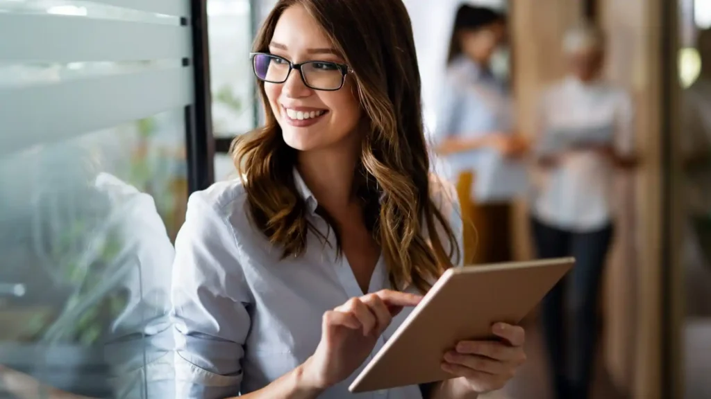 Young,Happy,Business,Woman,Working,With,Tablet,In,Corporate,Office