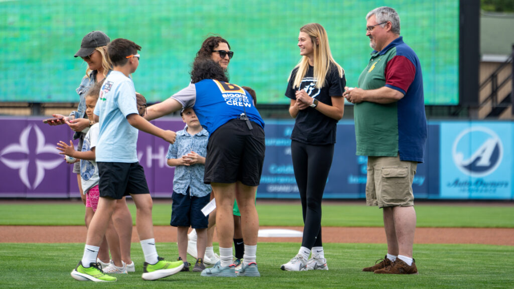 Emma Balkema representing the Grace Women’s Softball team throws out the first pitch at the Whitecaps Baseball Game.