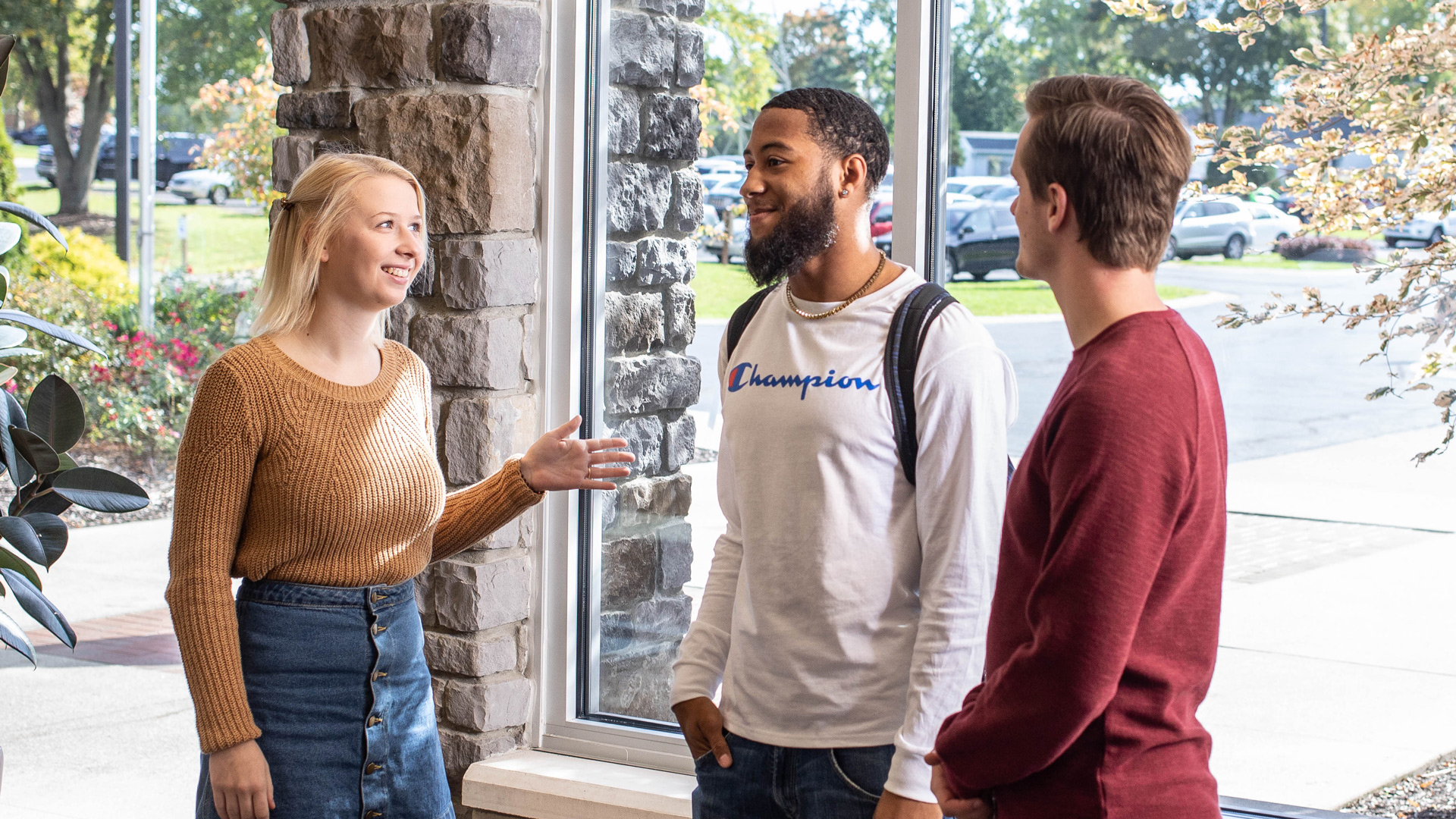 A group of Grace students standing around in the Commons