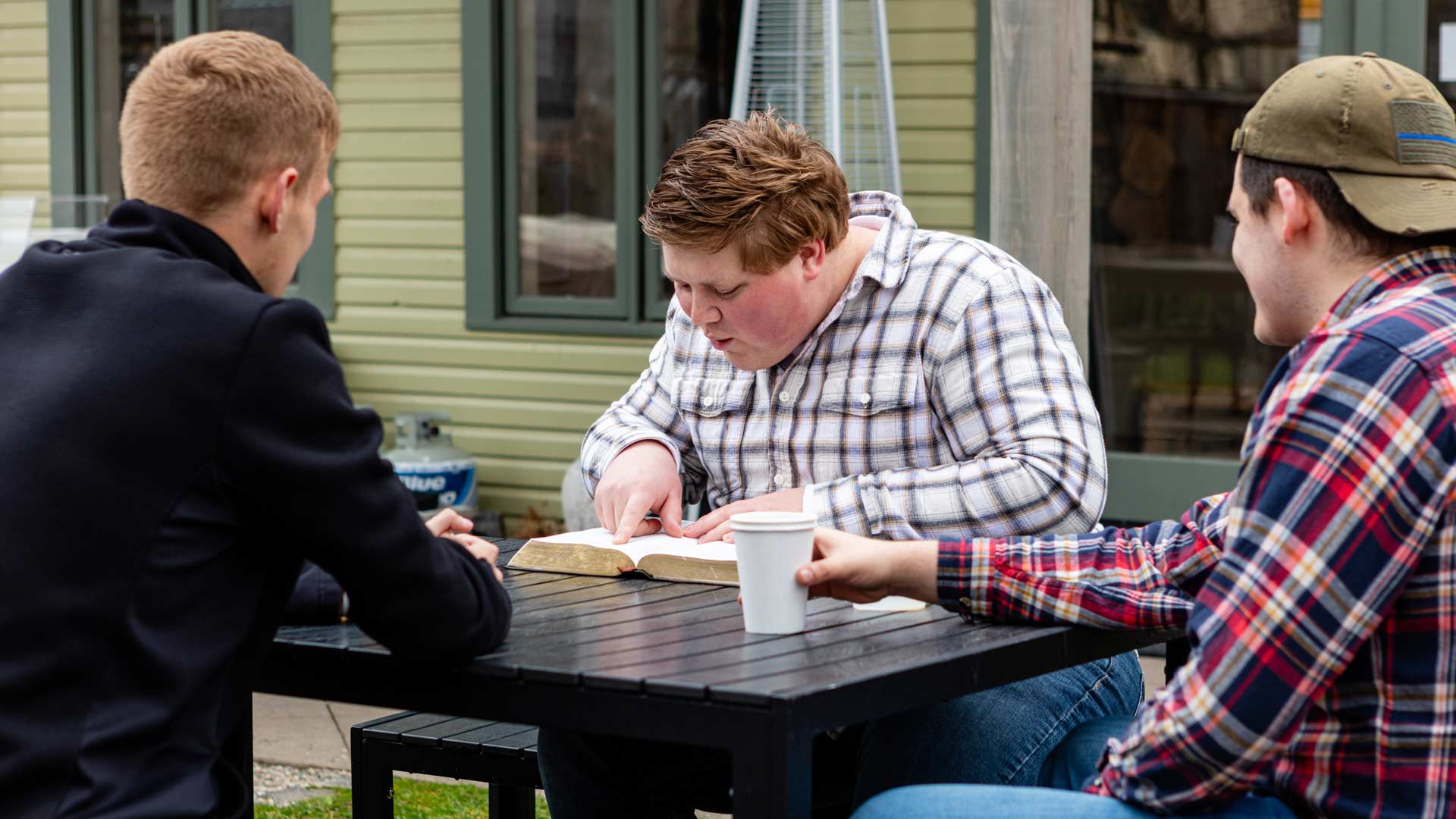 Grace students sitting outside doing a bible study