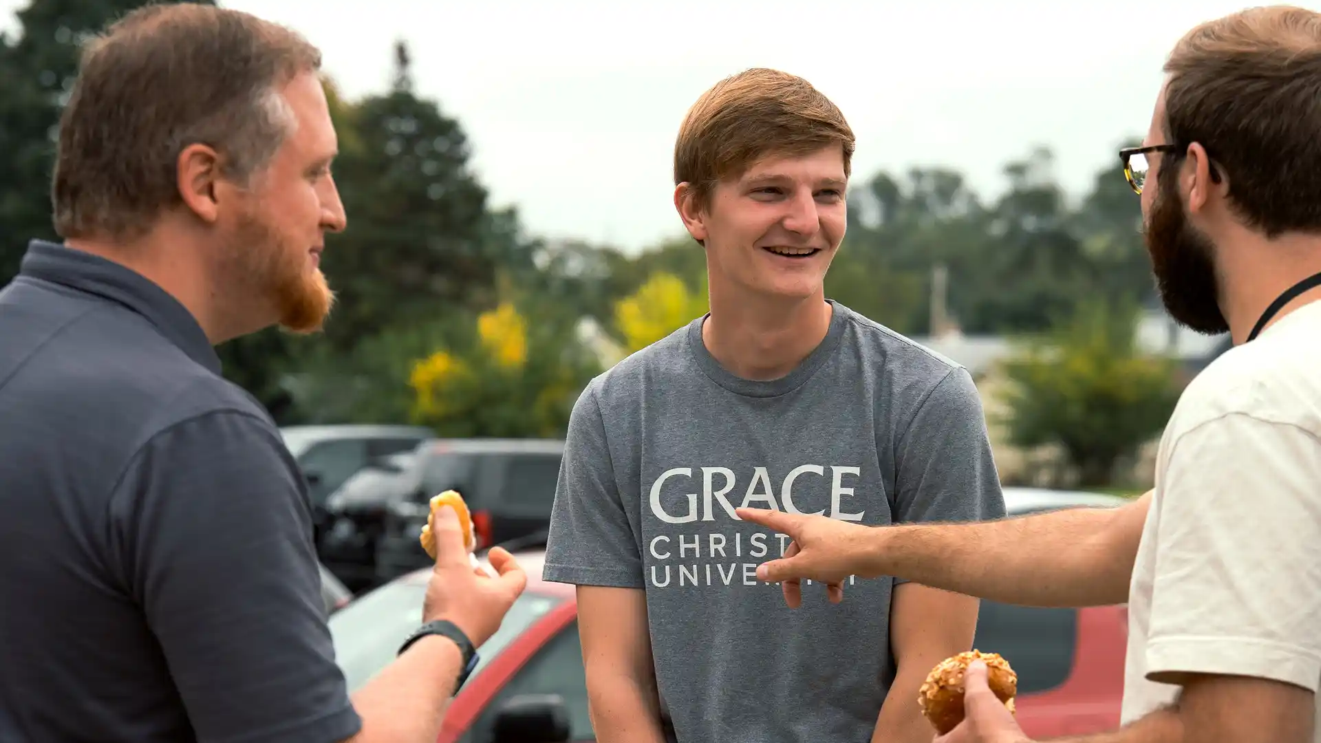 Grace alumni talking at a Homecoming event